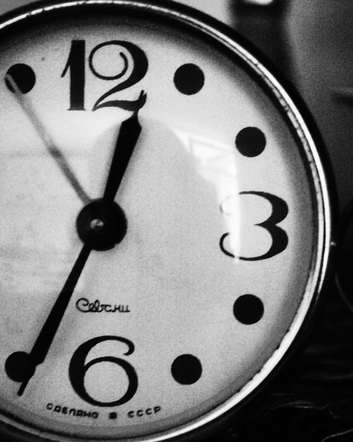 Close-up of a vintage clock face in black and white