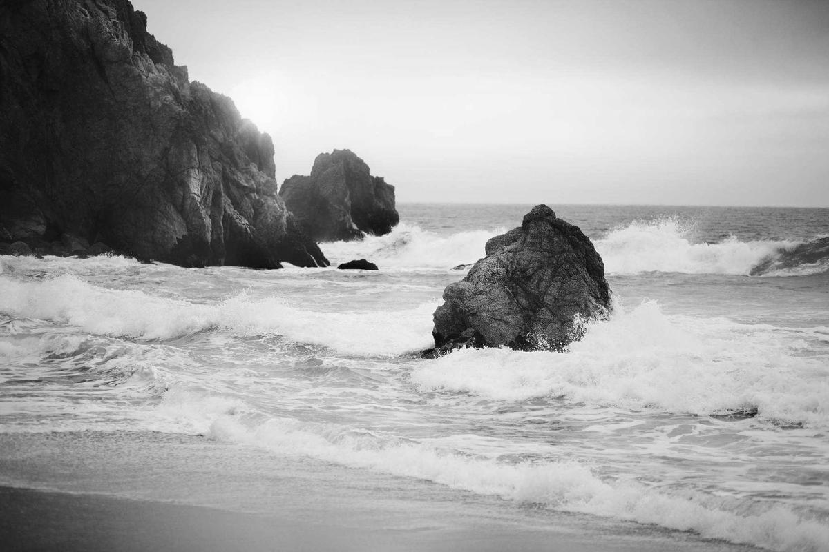 Rocky coastline at sunset with soft waves